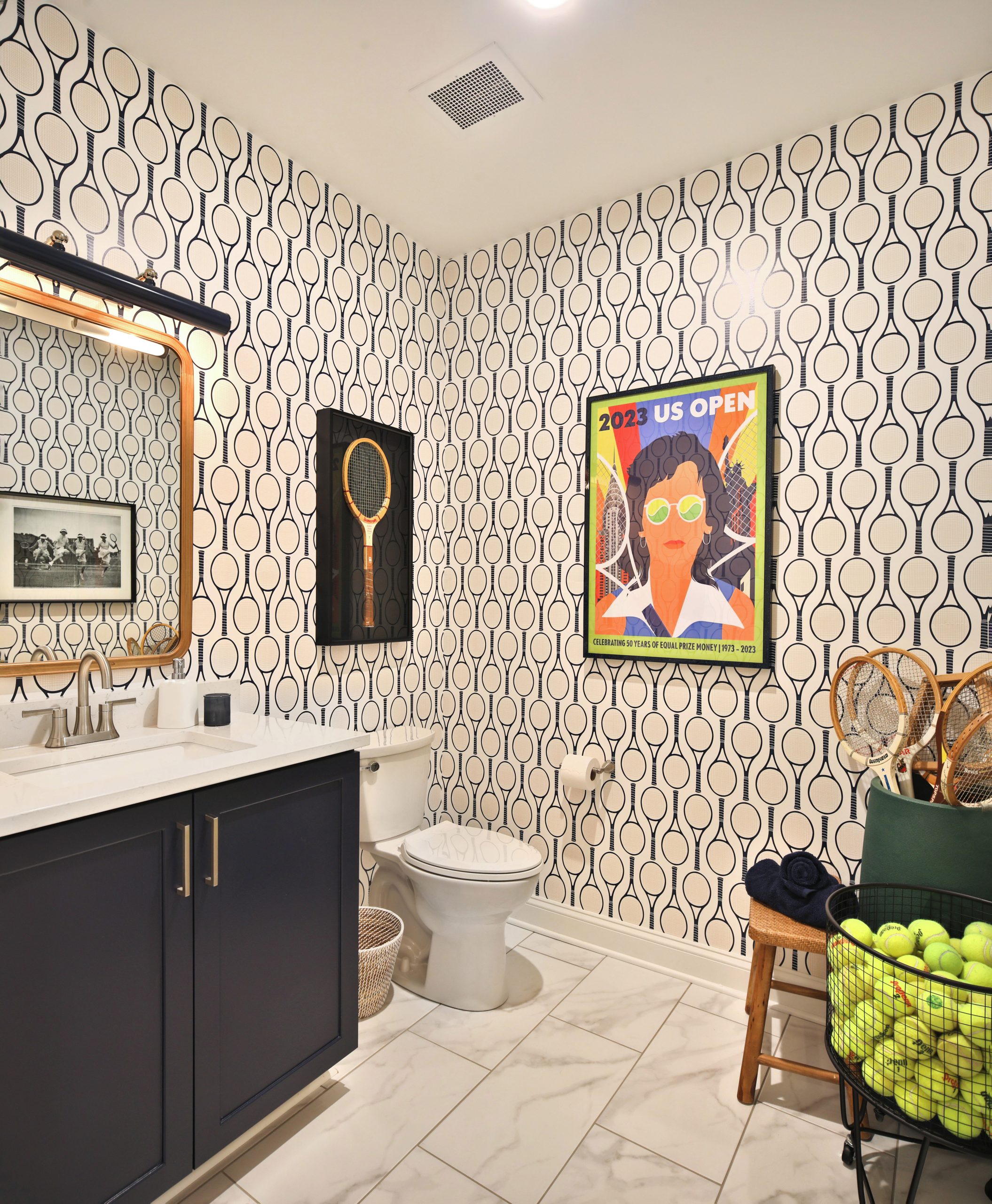 Custom designed bathroom in Westerville, Ohio condo with U.S. Open tennis theme wallpaper and decor.