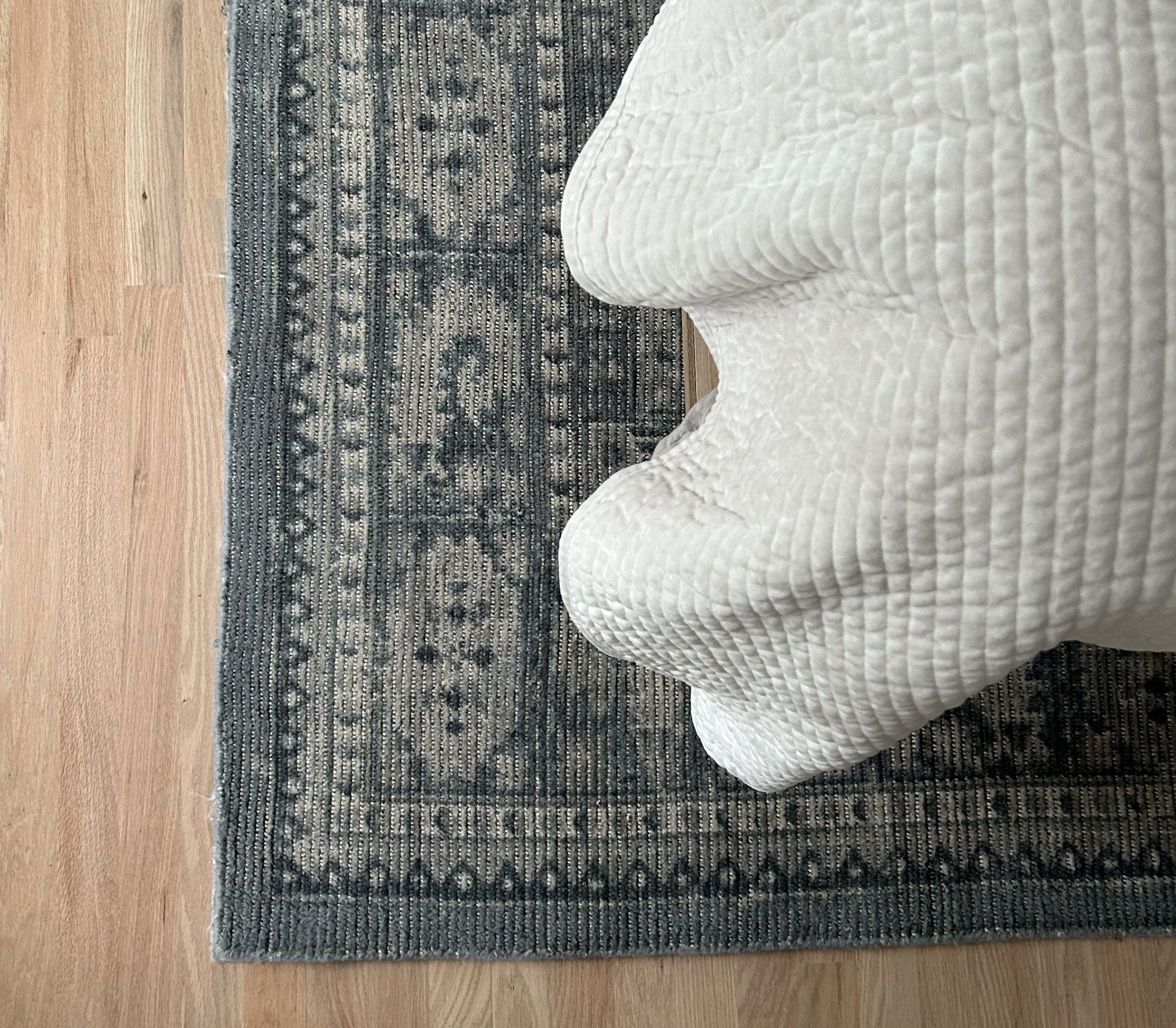 Overhead look of completed bedroom interior design for Columbus Ohio client featuring ornate blue woven rug.