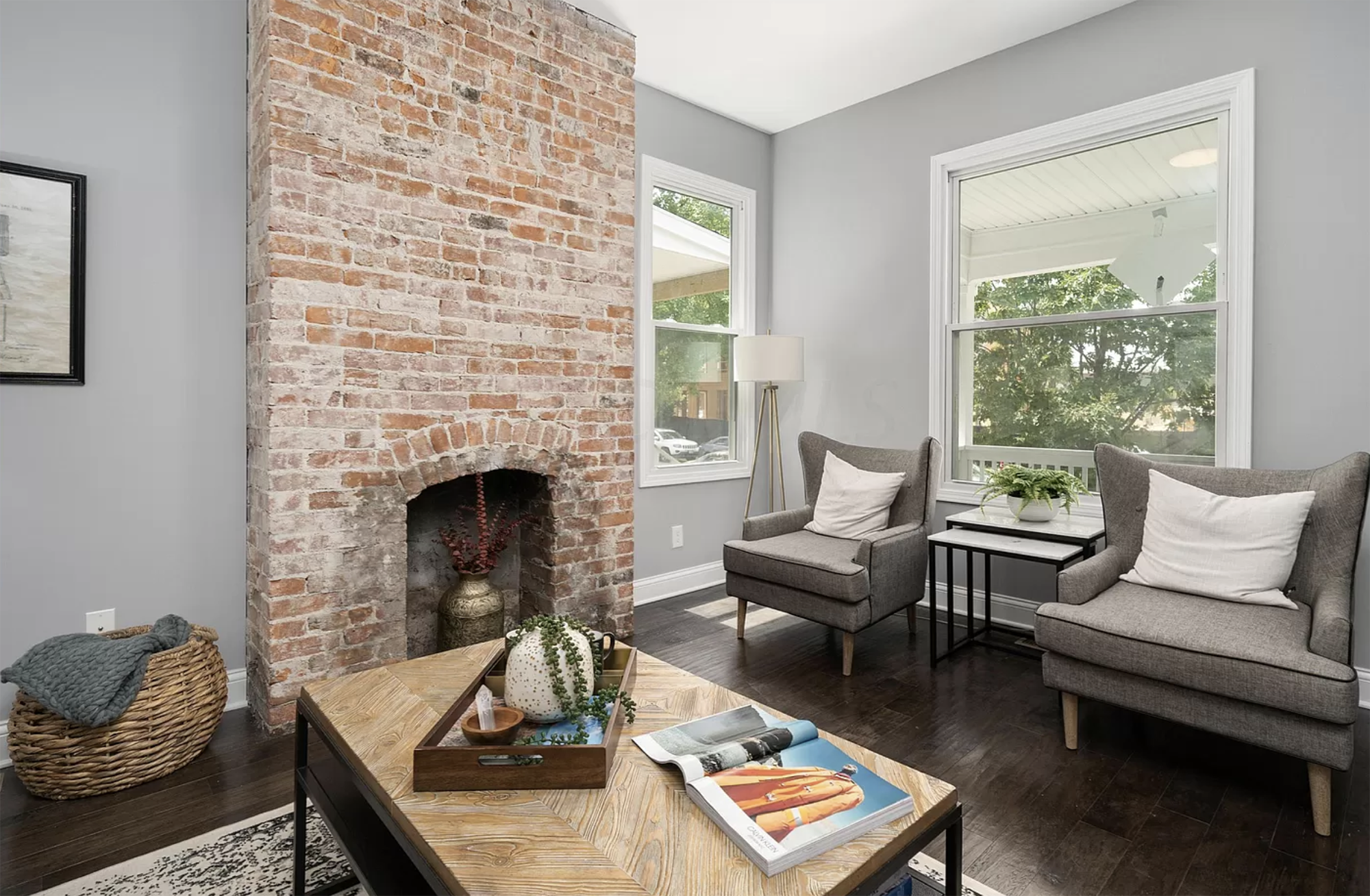 Exposed brick fire place, natural hardwood floors and modern decor in a renovated Pacific Palisades, California home.
