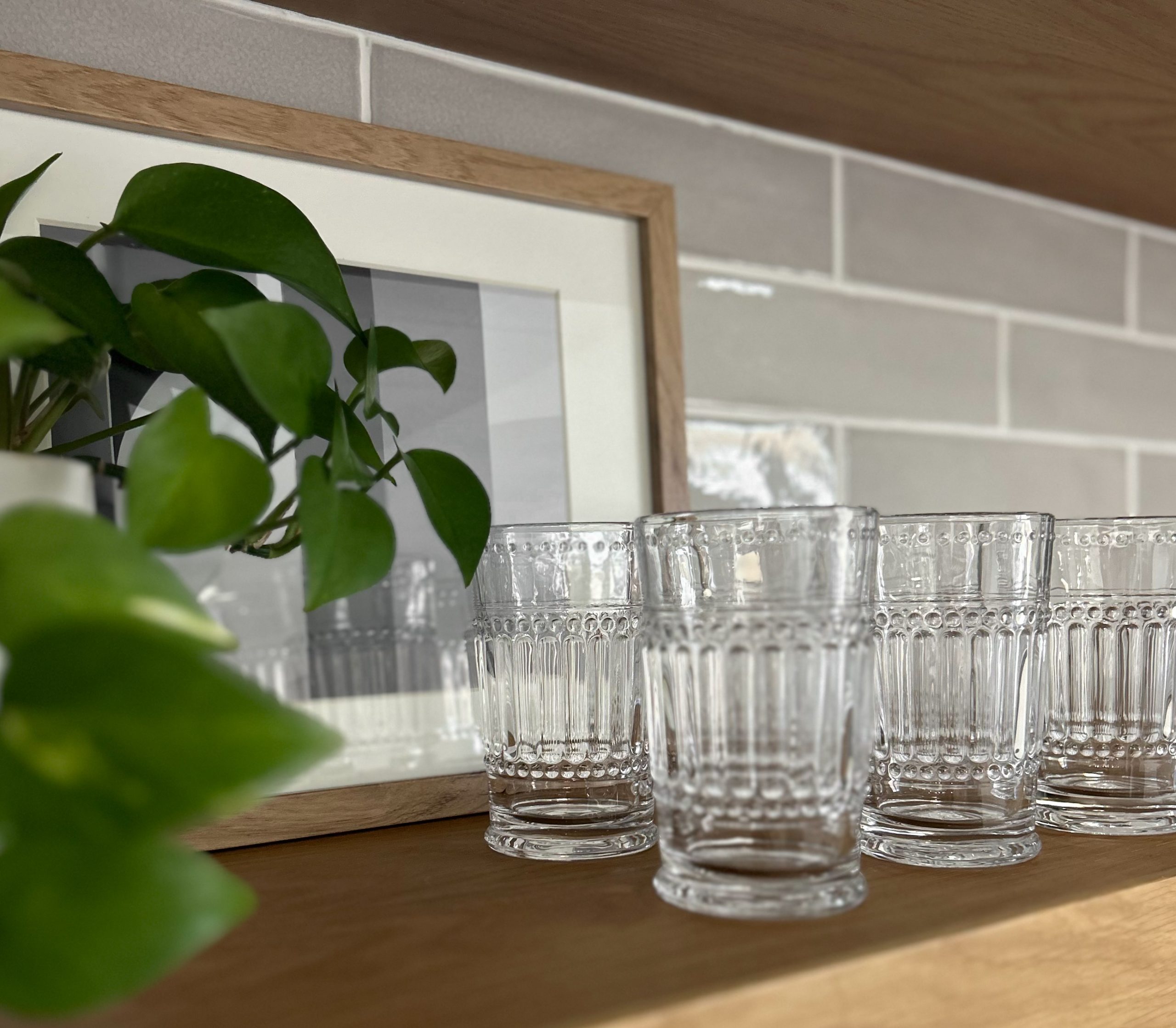 Finished interior design project for a commercial client featuring floating shelves and glassware.