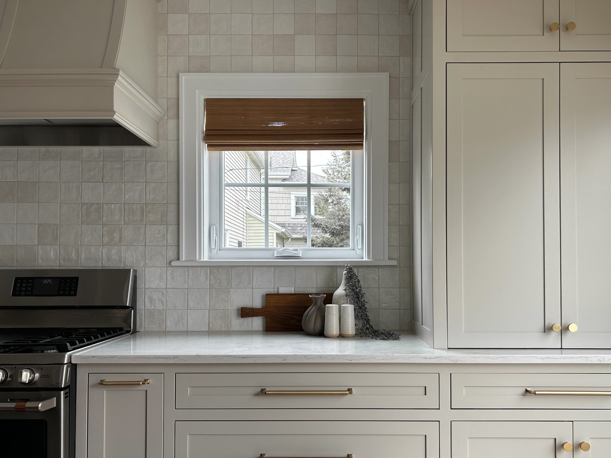 Complete remodeling of Clintonville, Ohio home in central Ohio with custom cabinetry and white tile backsplash and white counter tops.