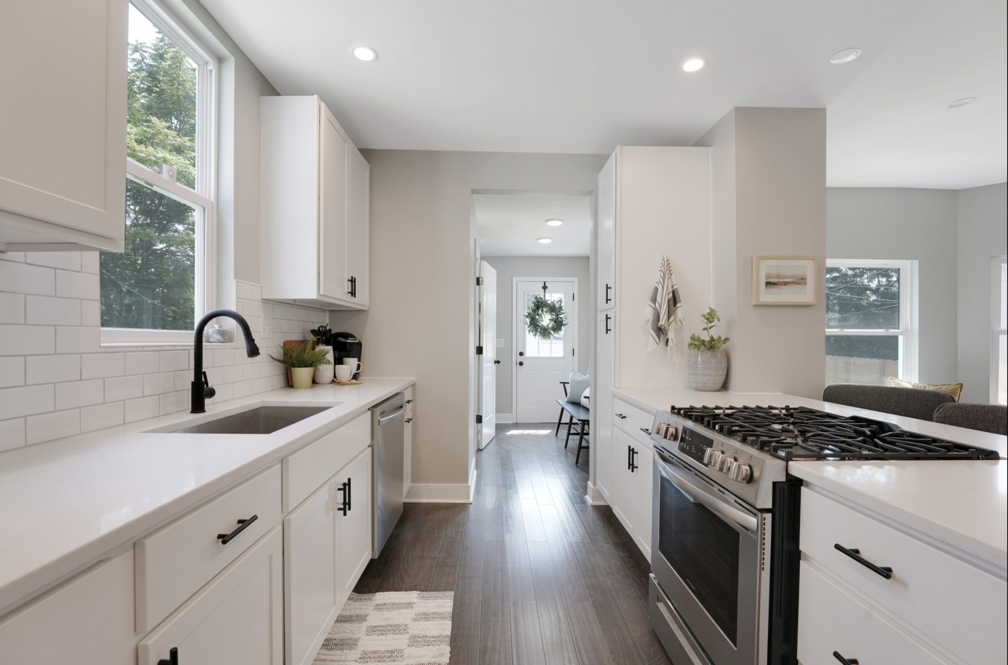 A full view of a remodeled kitchen in Southern Orchards district of downtown Pacific Palisades, California with solid surface countertops and stainless appliances.