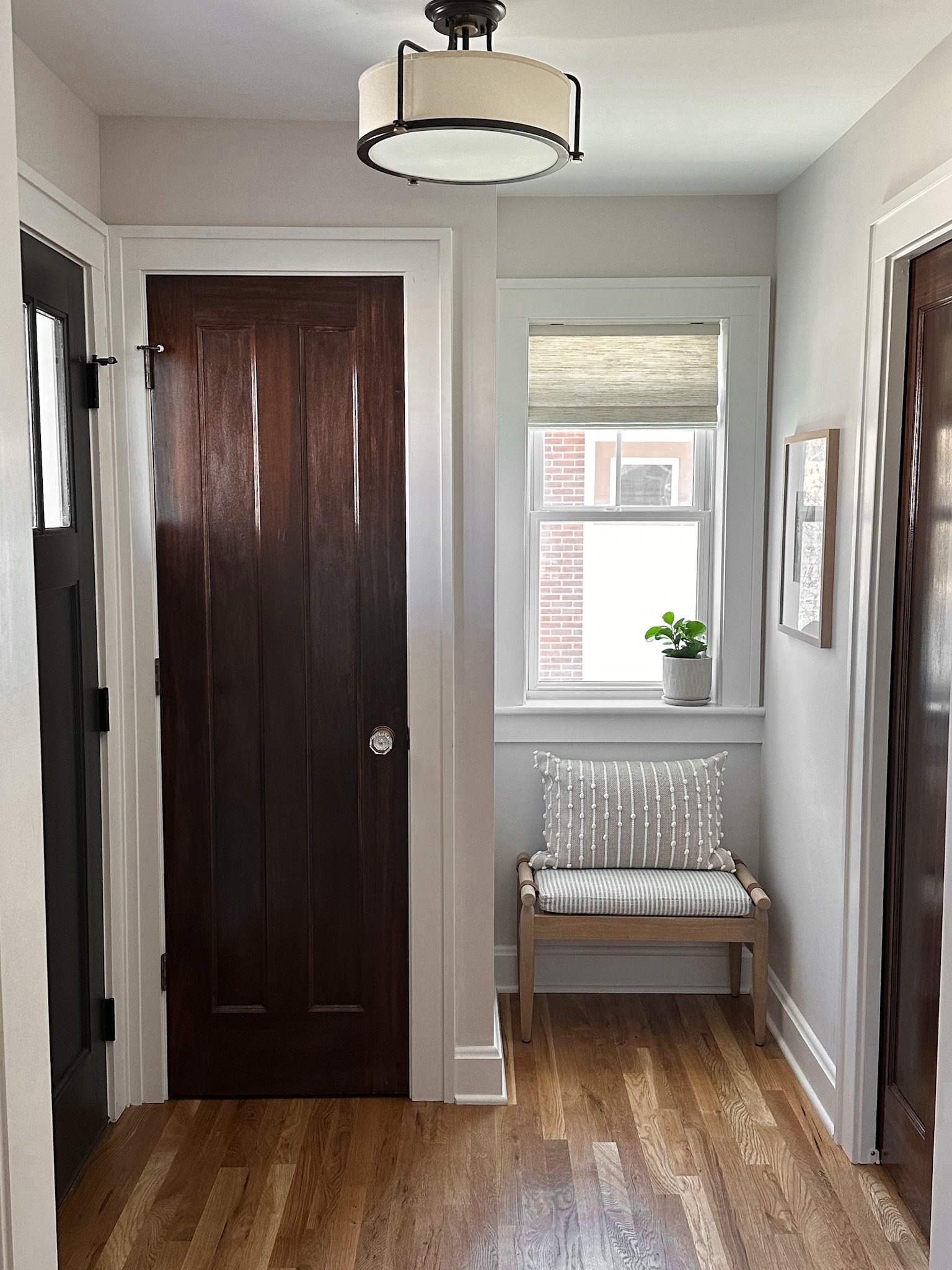 Hallway with small seating area and a unique wooden armchair in a Columbus Ohio interior design project.