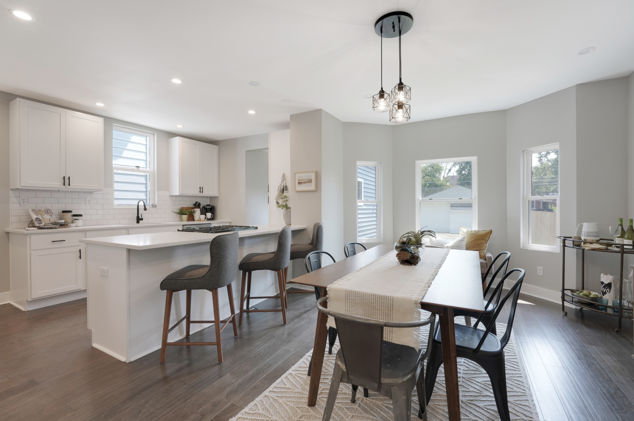 A kitchen & dining room space showcasing contemporary farmhouse decor and natural wood tones/textures.