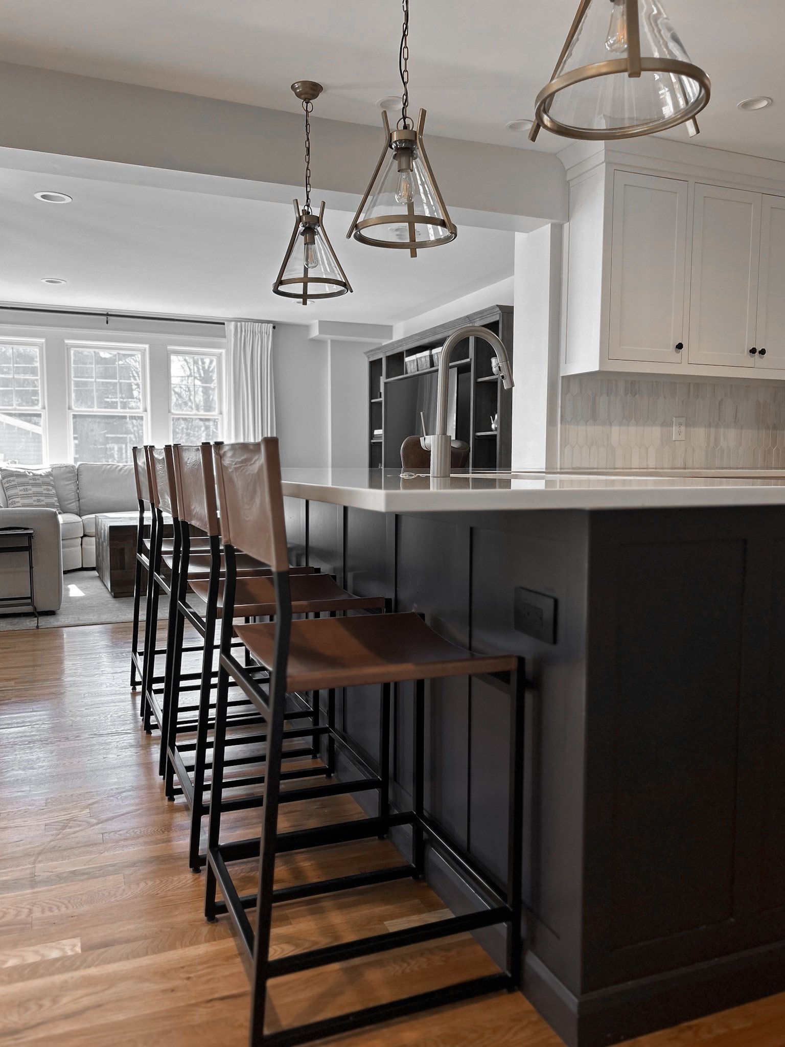 Custom kitchen design with leather barstools in a light modern industrial refined kitchen design.