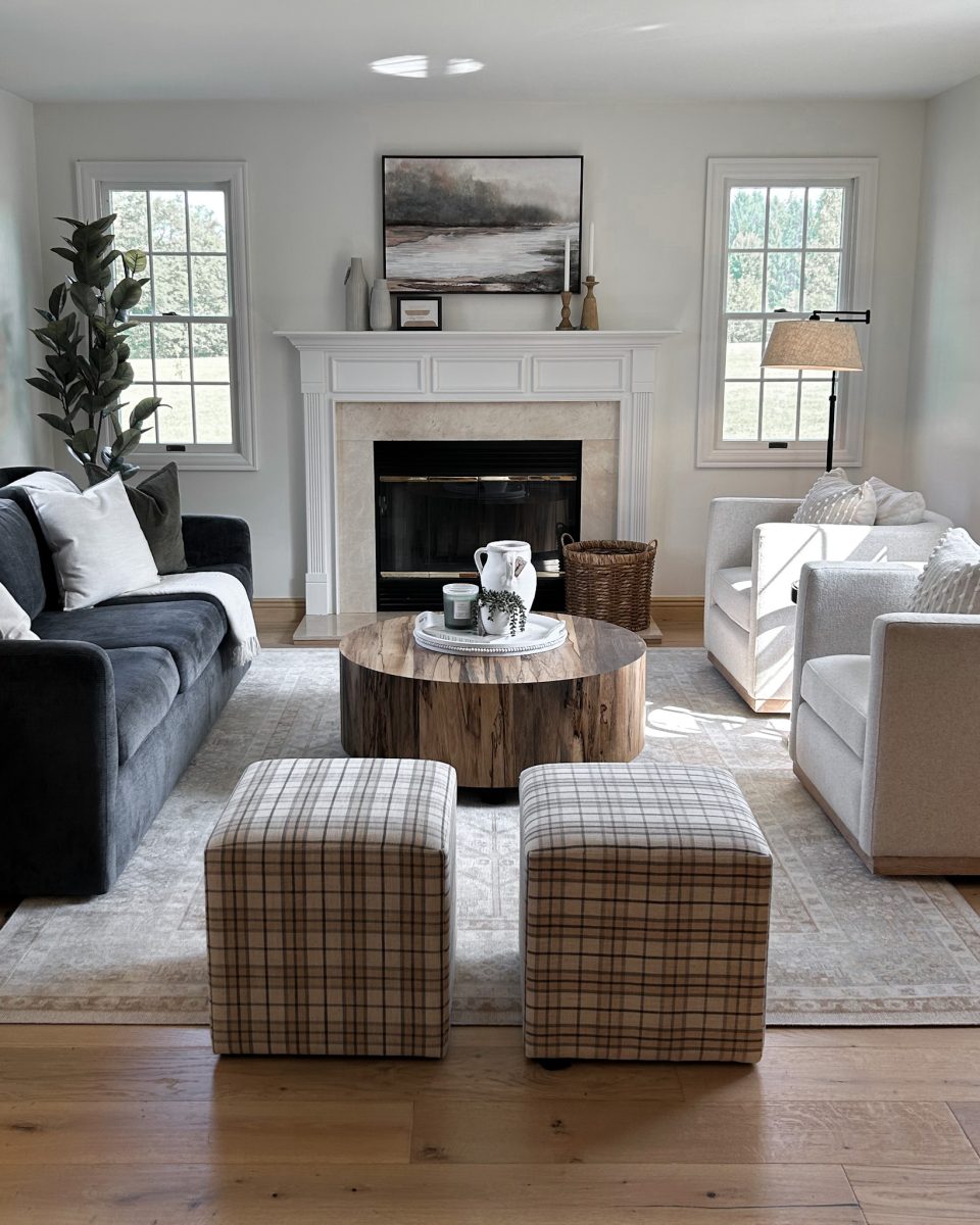 Pacific Palisades, California interior designers at Jennifer Donahue Interior Design Inc designed this living room with a large sofa, ottomans, occasional chairs and coffee table.