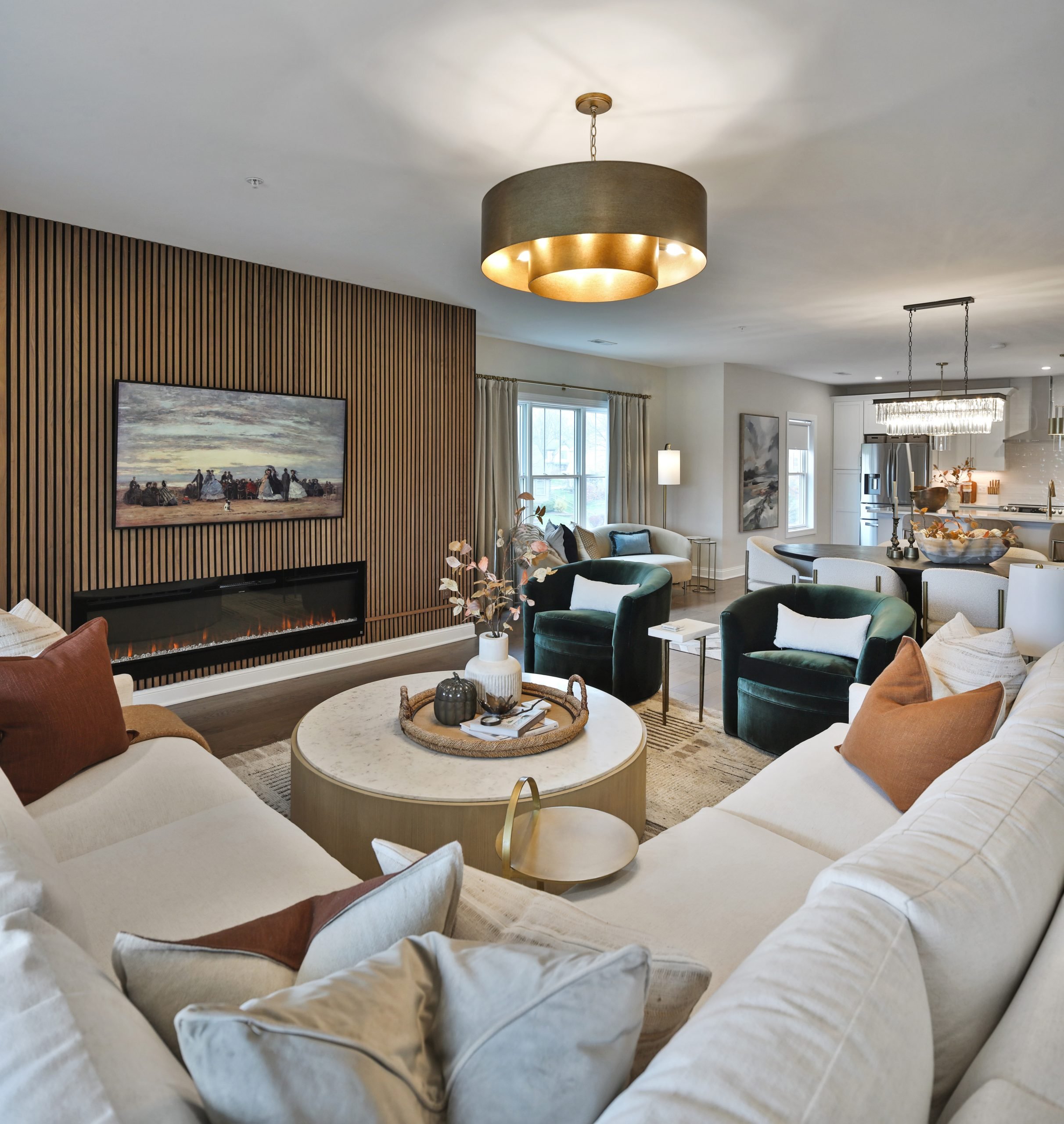 Living room with sectional sofa, large round coffee table and built in fireplace.