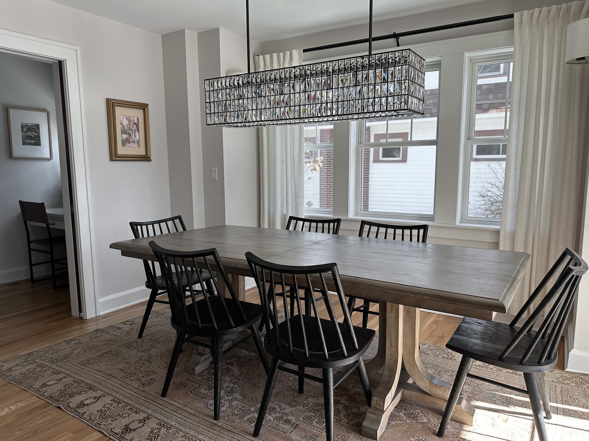 Natural wood dining table and dining chairs create a stunning natural atmosphere in this luxury Pacific Palisades, California interior design project.