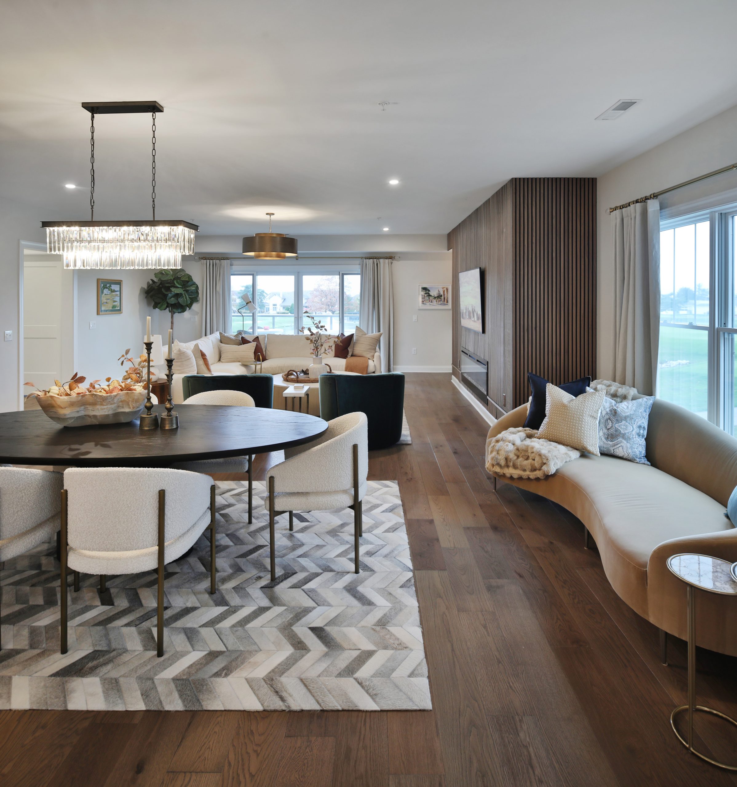 Overlooking a luxury dining space into a living room in a central Ohio condo up against country club golf course.