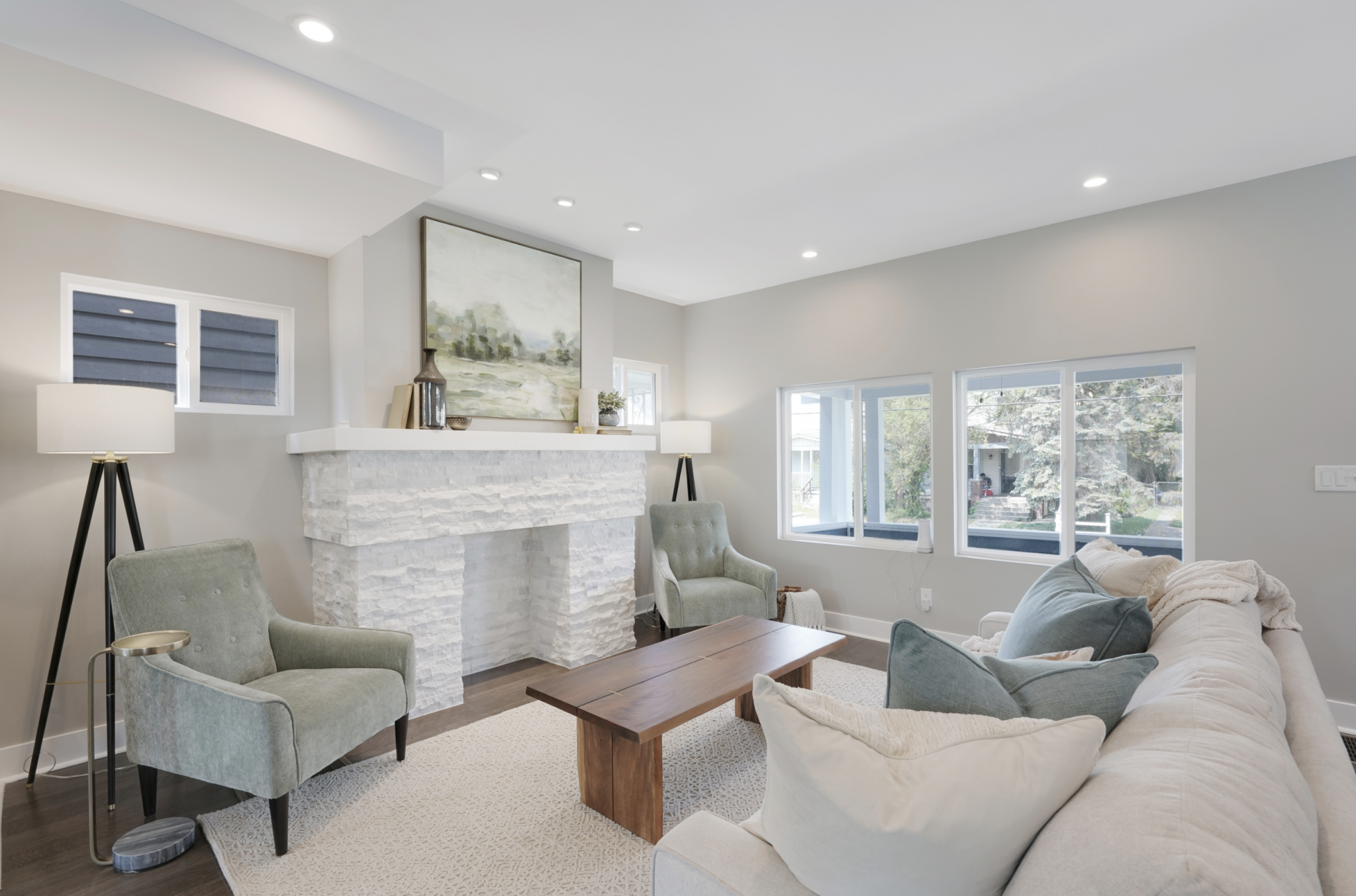 Modern living room furniture and decor creates with suede occasional chars, white sofa and modern floor lamps.