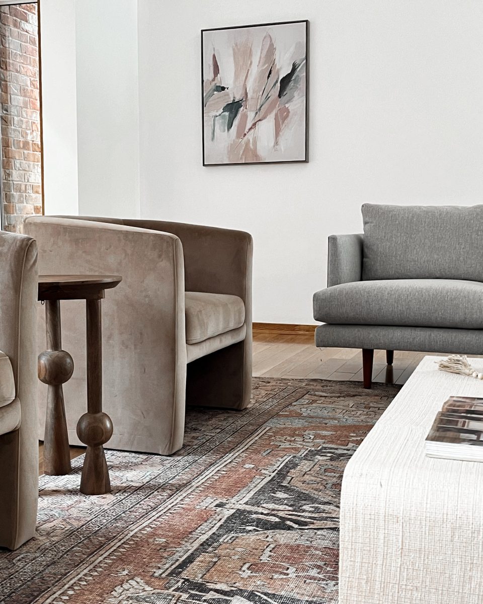 modern occasional bucket chairs, sofa and modern side table makes a living room feel like home in a Worthington, Ohio listing.
