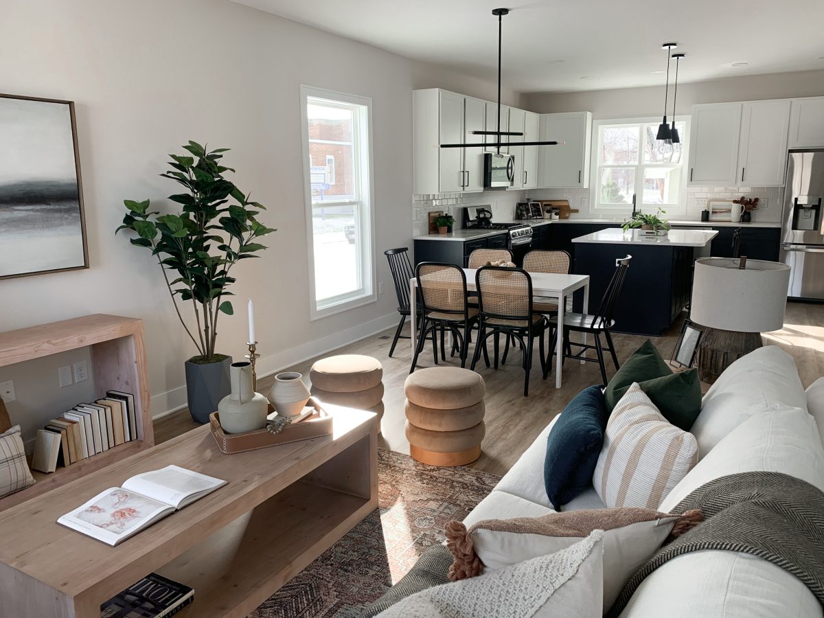 Modern occasional chairs, wooden coffee tables and consoles create a natural stylish living room area in a Pacific Palisades, California home.