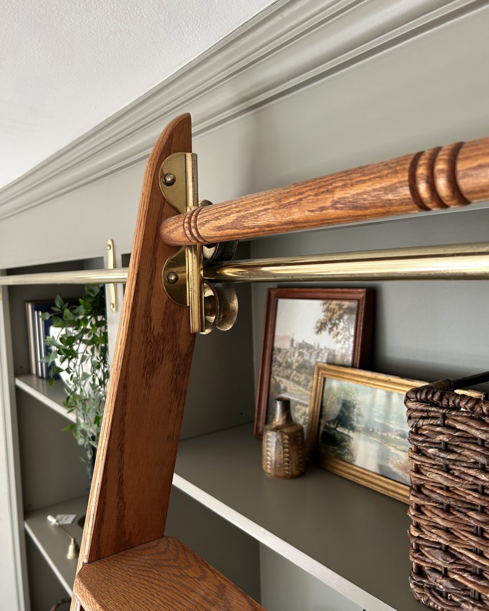 Interior design project with rolling wooden ladder bookshelf.