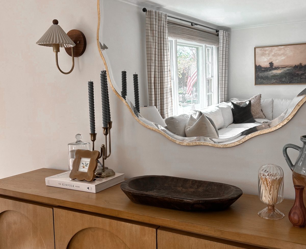 living room design featuring a console with decorative tray and candle holder.