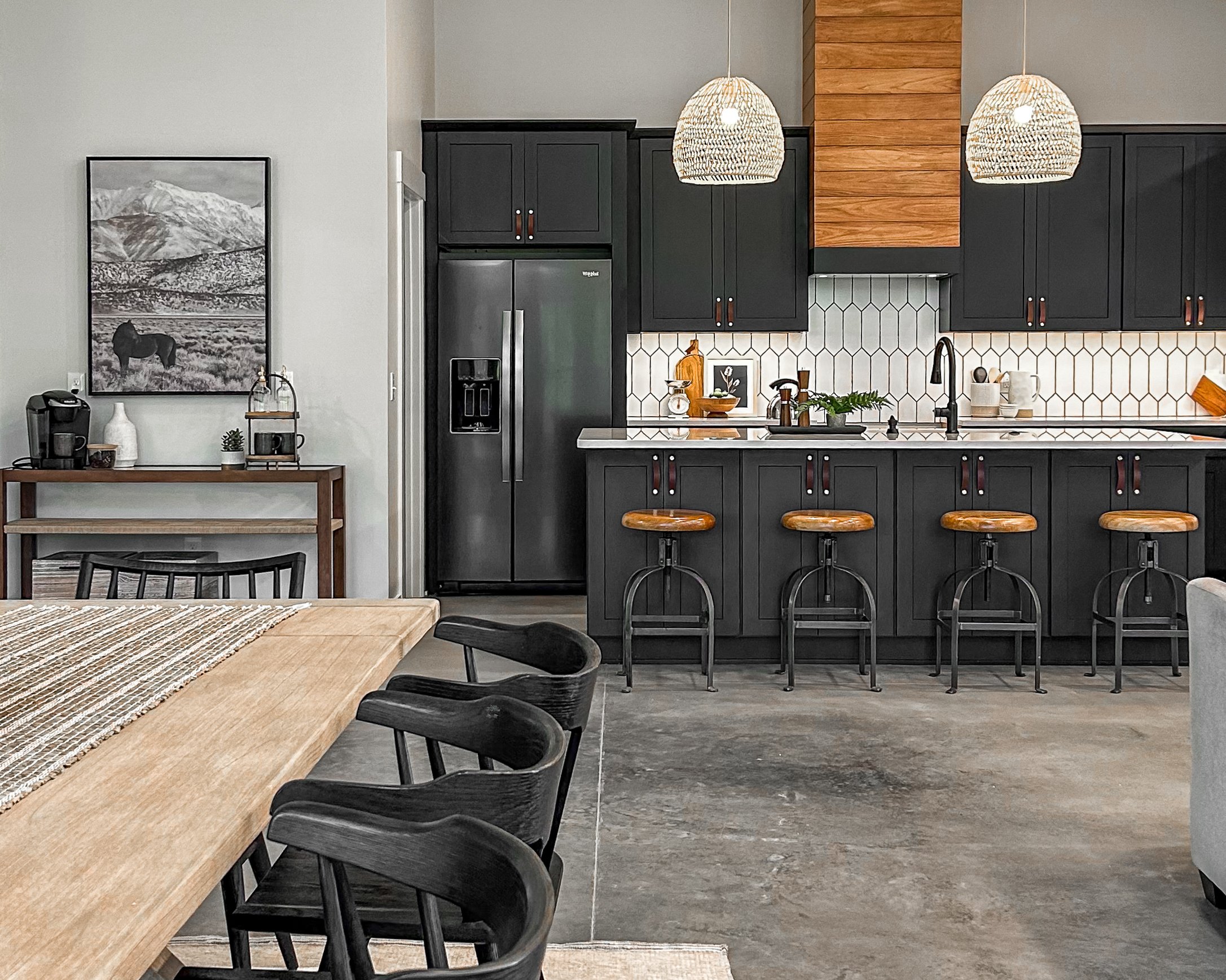 New Barn style home in Plain City, Ohio featuring an open floor plan with dining space flowing into kitchen. Industrial bar stools and modern dining room furniture and decor.