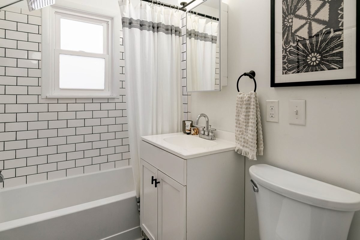 Monochromatic remodeled full bathroom staged in downtown Pacific Palisades, California home.
