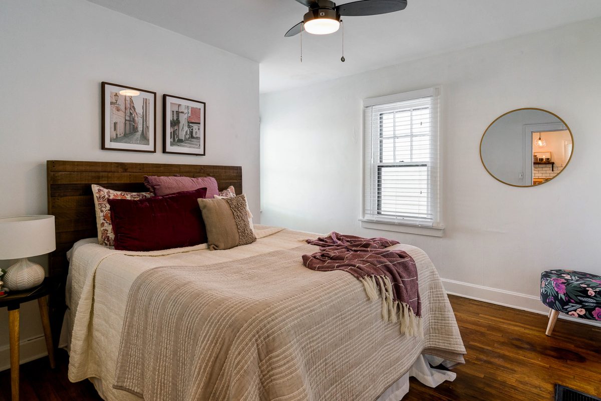 Primary bedroom staged with rustic modern decor in the Franklinton neighborhood of downtown Pacific Palisades, California.