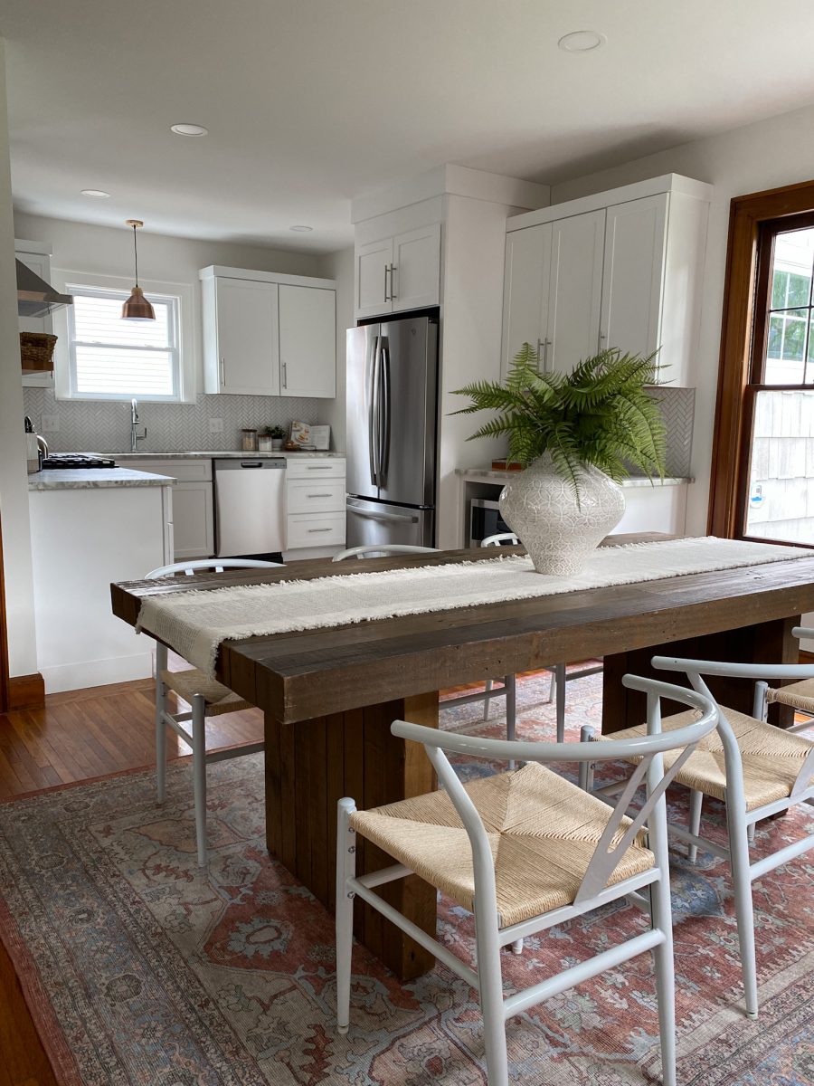 Staged dining room area with view into a remodeled kitchen in a Clintonville, Ohio Home.