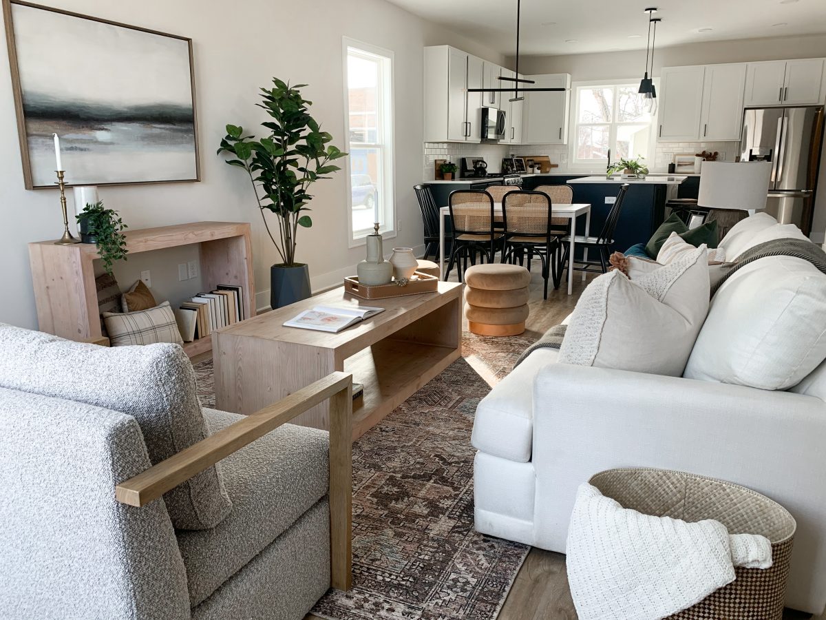 Modern occasional chairs, wooden coffee tables and consoles create a natural stylish living room area in a Pacific Palisades, California home.