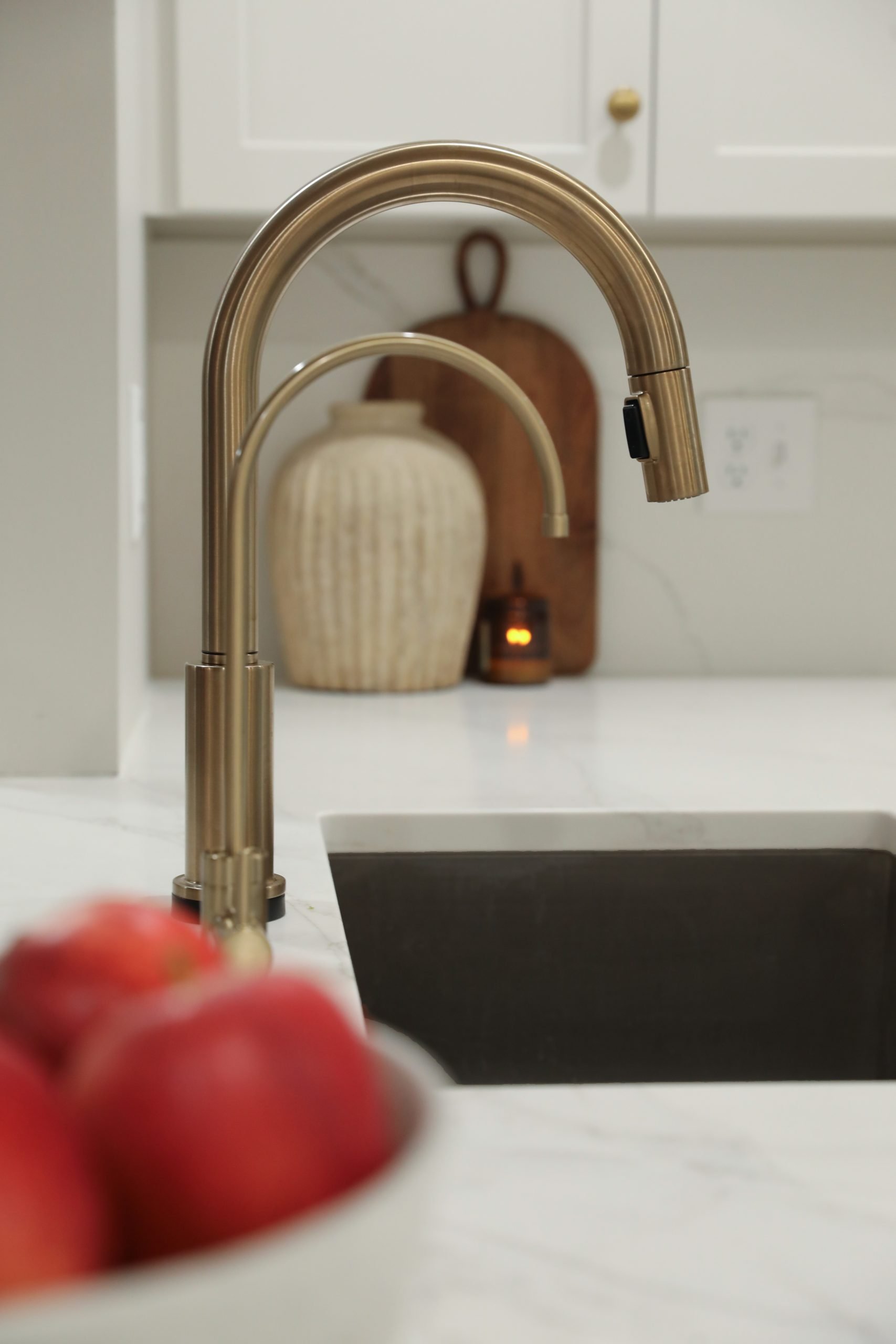 Remodeled kitchen in a central Ohio home featuring a luxury brass finished inlayed on white stone countertops.