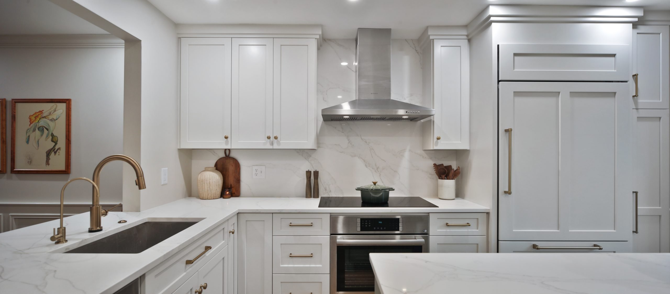 Remodeled kitchen in a central Ohio, home featuring large white countertops, custom cabinetry and beautiful appliances.