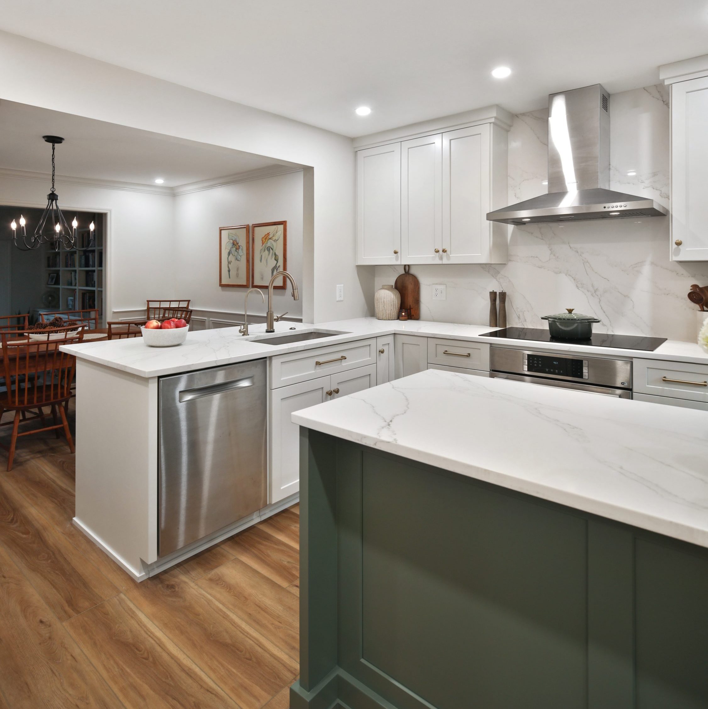 Diagonal view of a completely remodeled kitchen featuring custom cabinets, large island, spacious open floor plan.