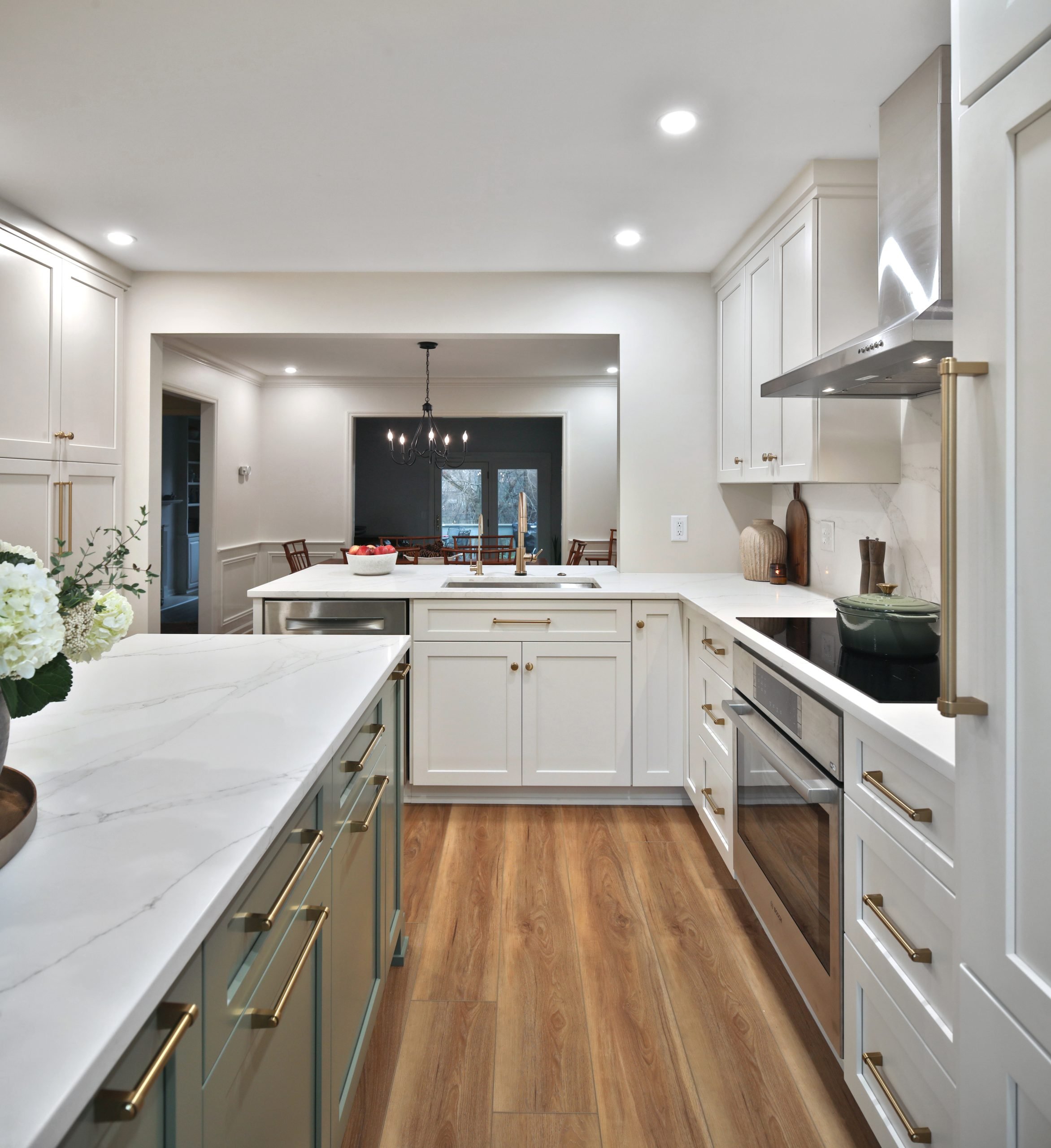 White countertops and custom cabinets installed in a fully remodeled kitchen with luxury modern decor.