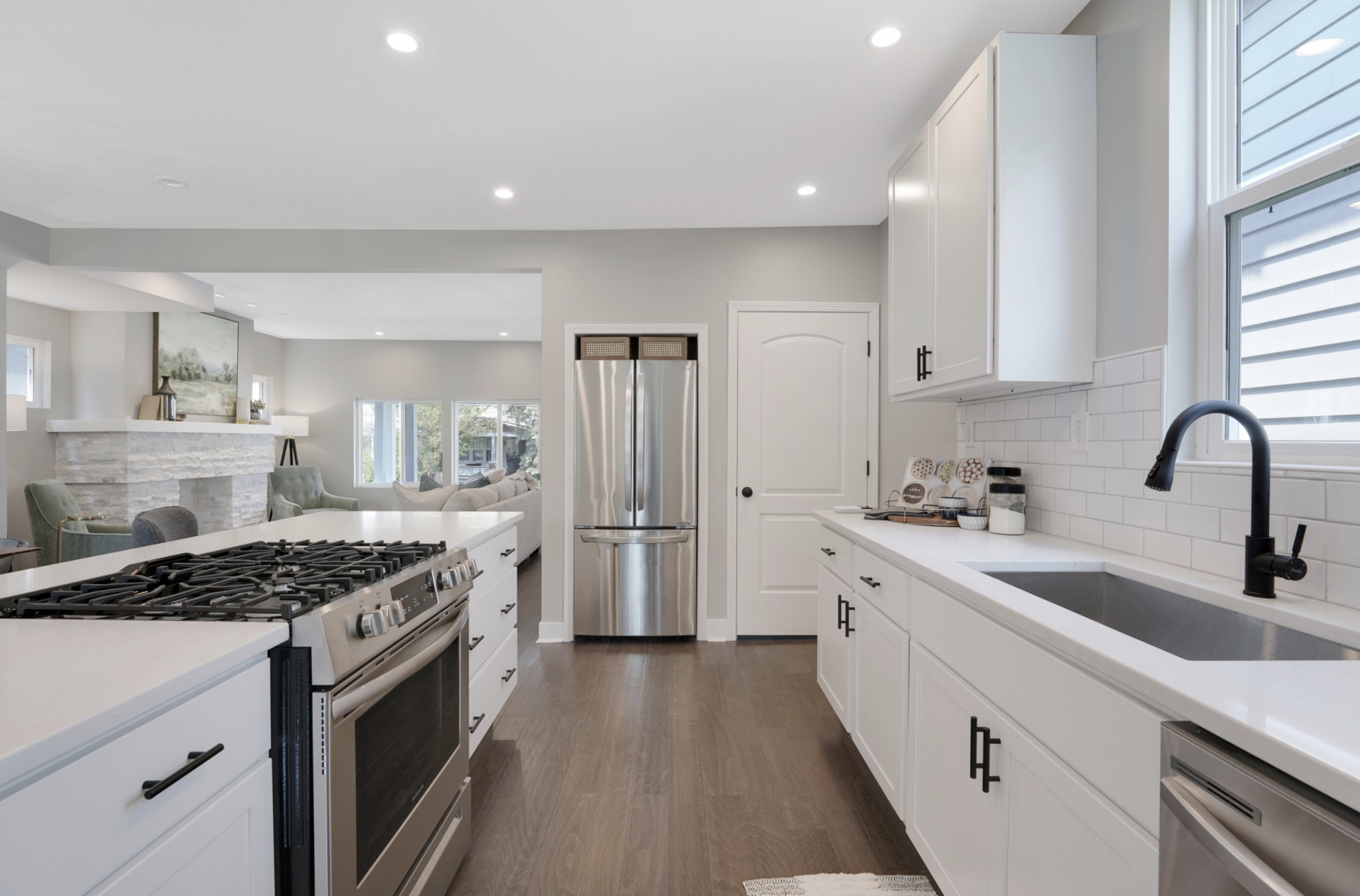 Fully remodeled kitchen with white cabinets and stainless steel appliances.