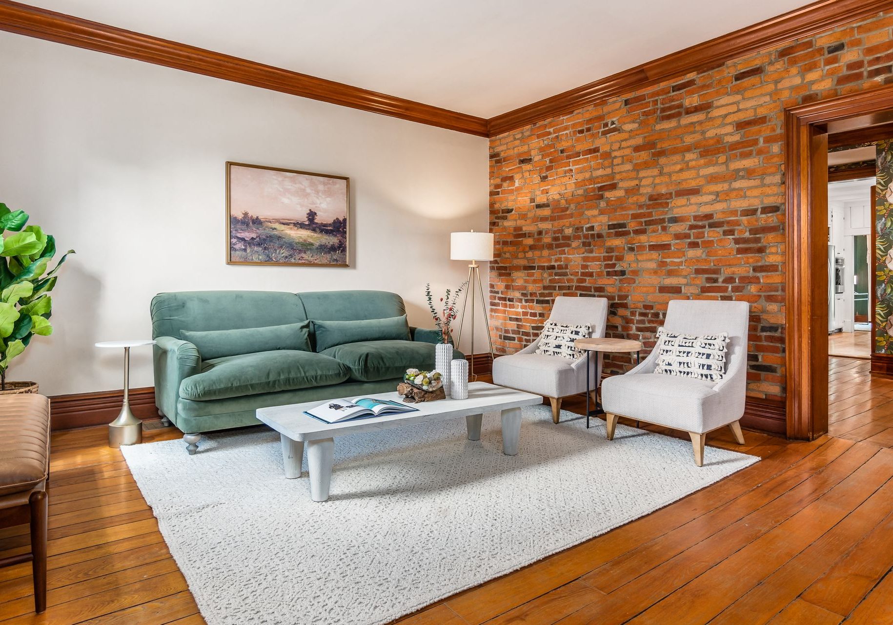 Historic German Village living room with a blend of modern and classic furniture that ties together the exposed brick, original woodwork and modern updates.