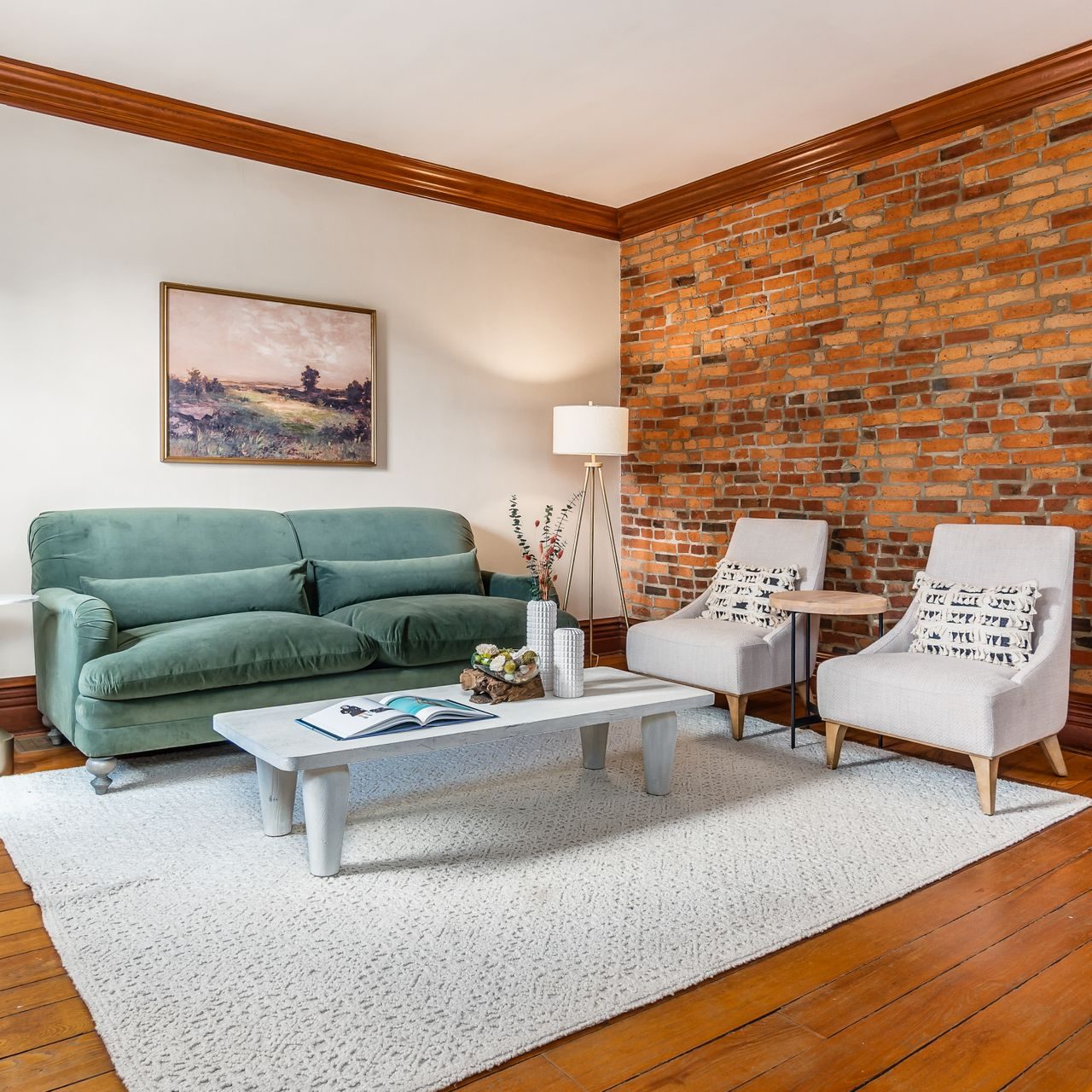 Historic German Village living room with a blend of modern and classic furniture that ties together the exposed brick, original woodwork and modern updates.