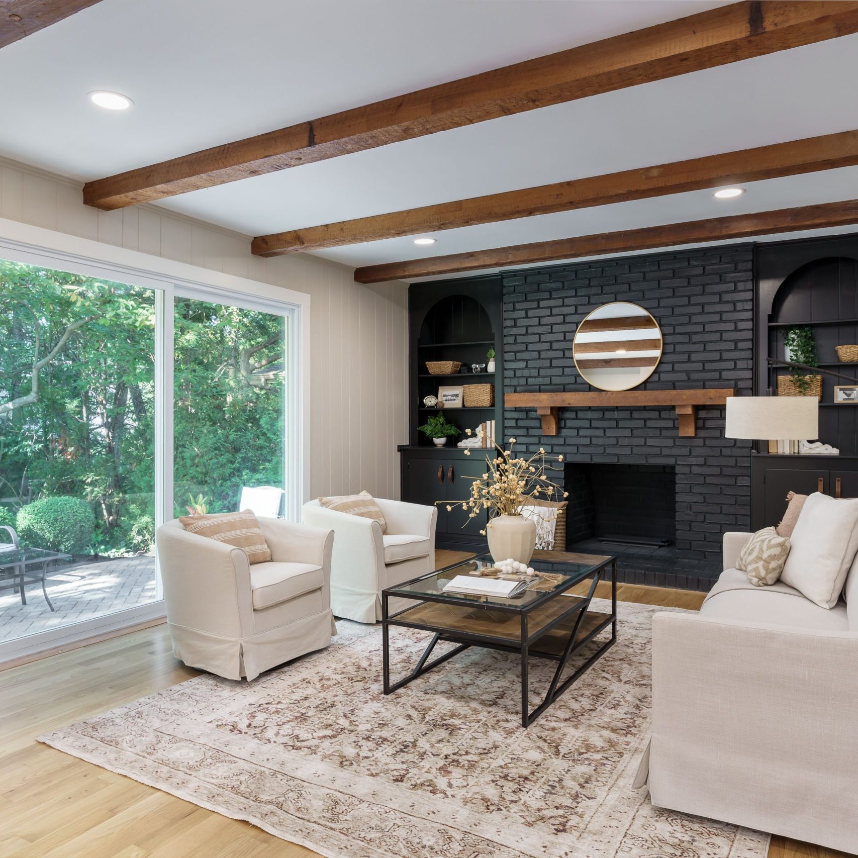 Living room design in a central Ohio staging completed with swivel round back chairs, large sofa and industrial coffee table.