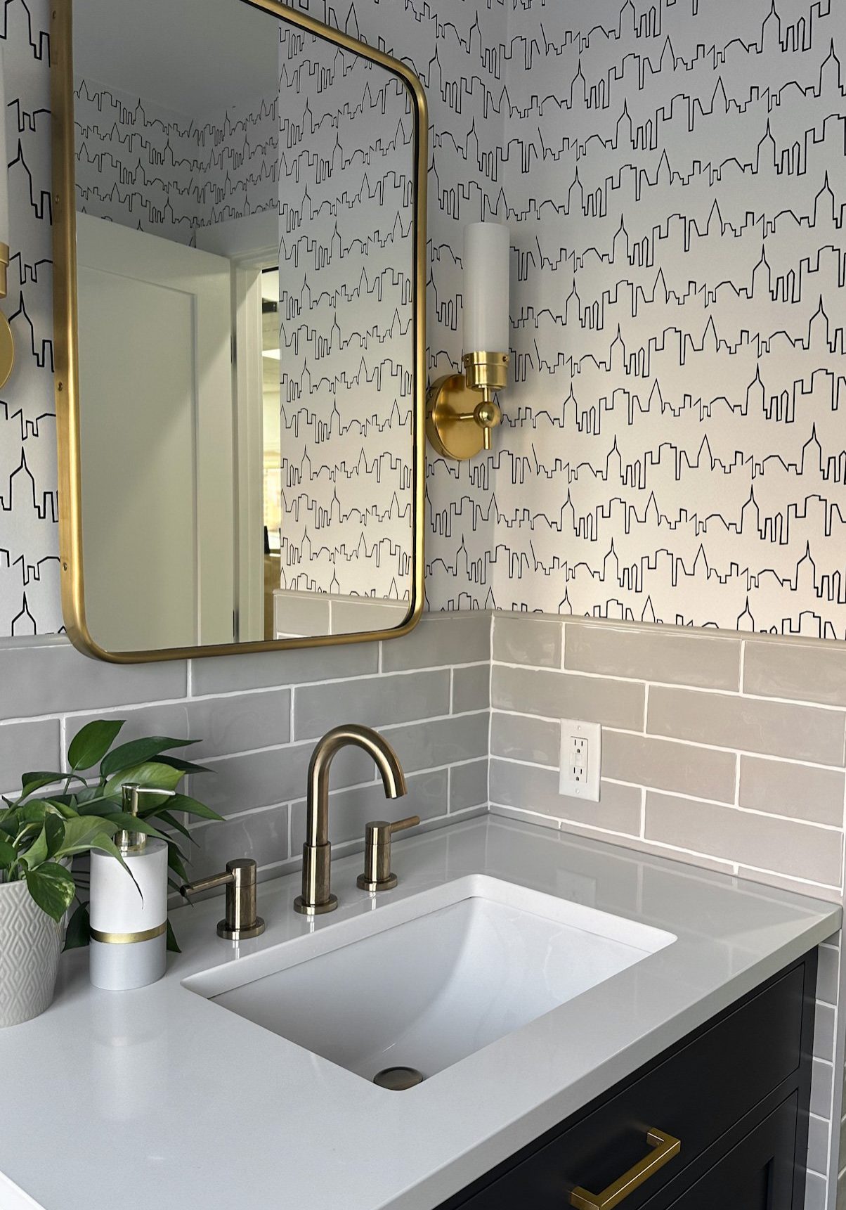 Modern bathroom renovation in Columbus real estate office with skyline wallpaper.