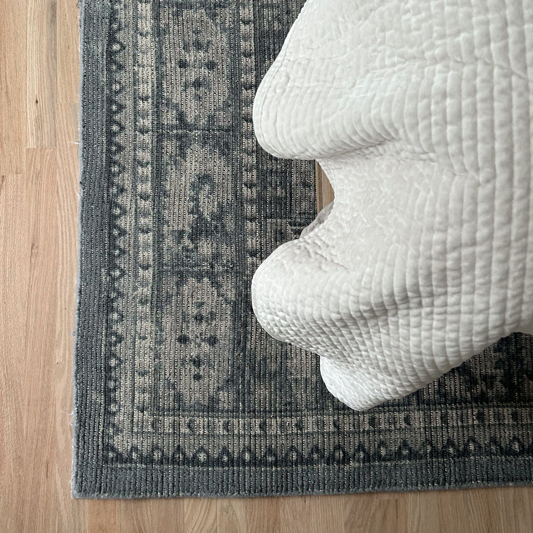 Overhead look of completed bedroom interior design for Columbus Ohio client featuring ornate blue woven rug.