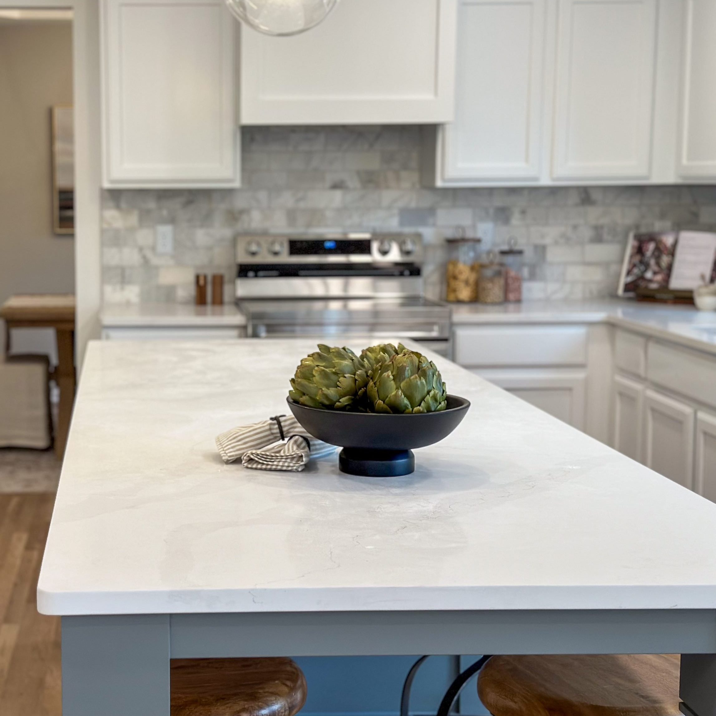 Remodeled kitchen space in a Dublin Ohio home with white countertops, white cabinets and new appliances.