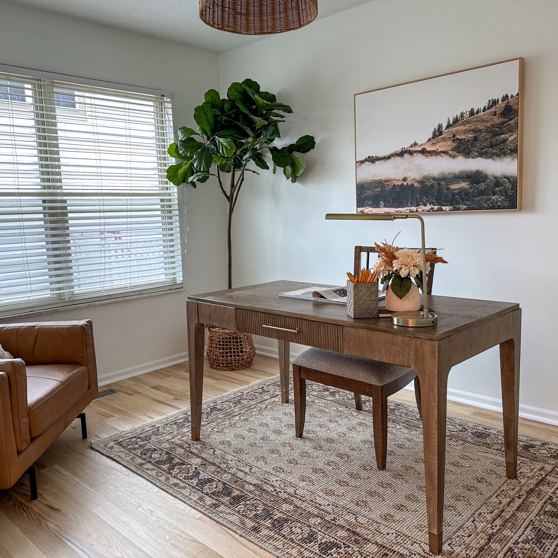 Home office design in Dublin, Ohio, home featuring classic wooden desk and leather mid century arm chair.