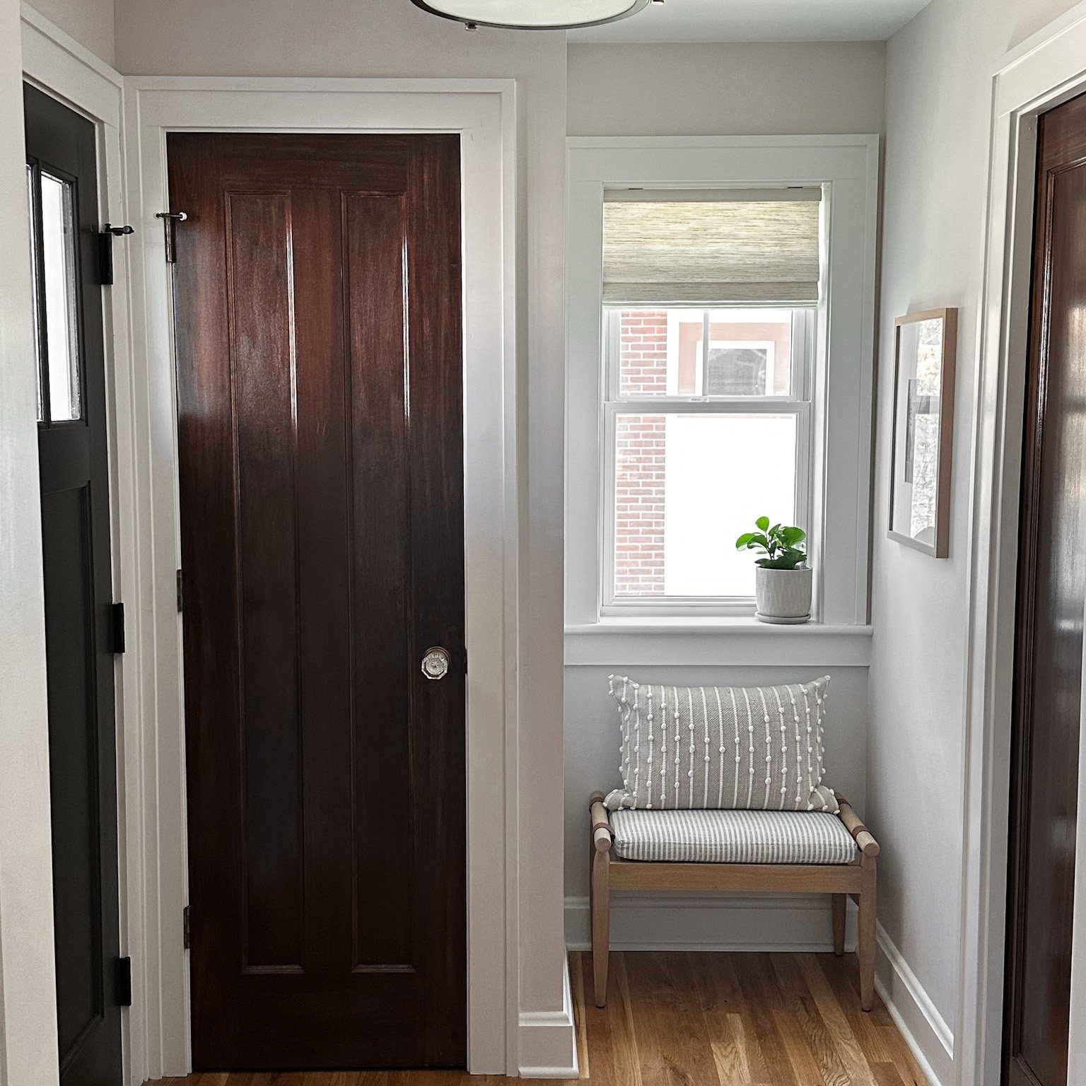 Hallway with small seating area and a unique wooden armchair in a Columbus Ohio interior design project.