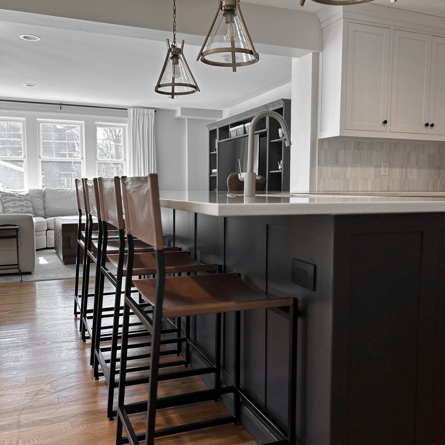 Custom kitchen design with leather barstools in a light modern industrial refined kitchen design.
