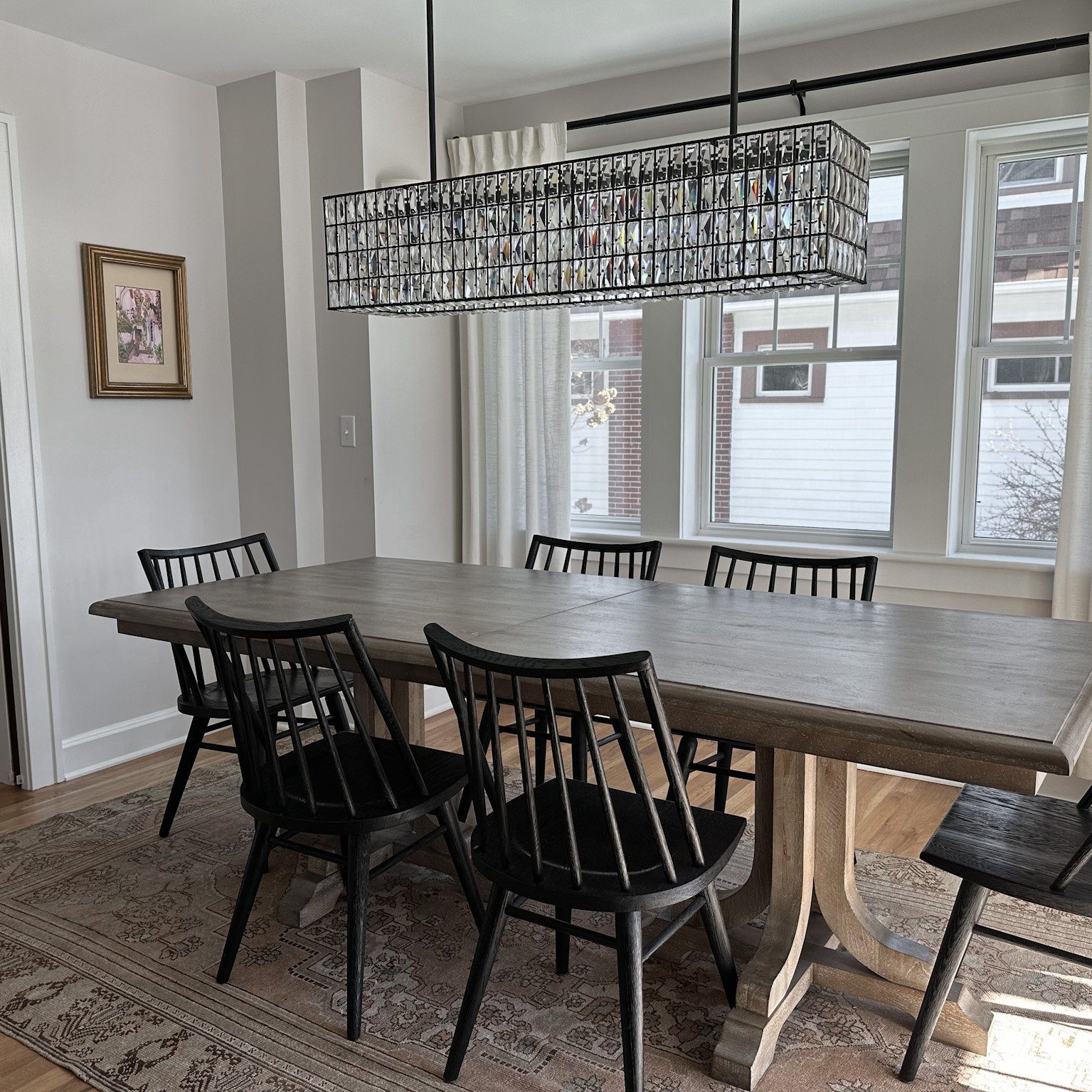 Natural wood dining table and dining chairs create a stunning natural atmosphere in this luxury Pacific Palisades, California interior design project.