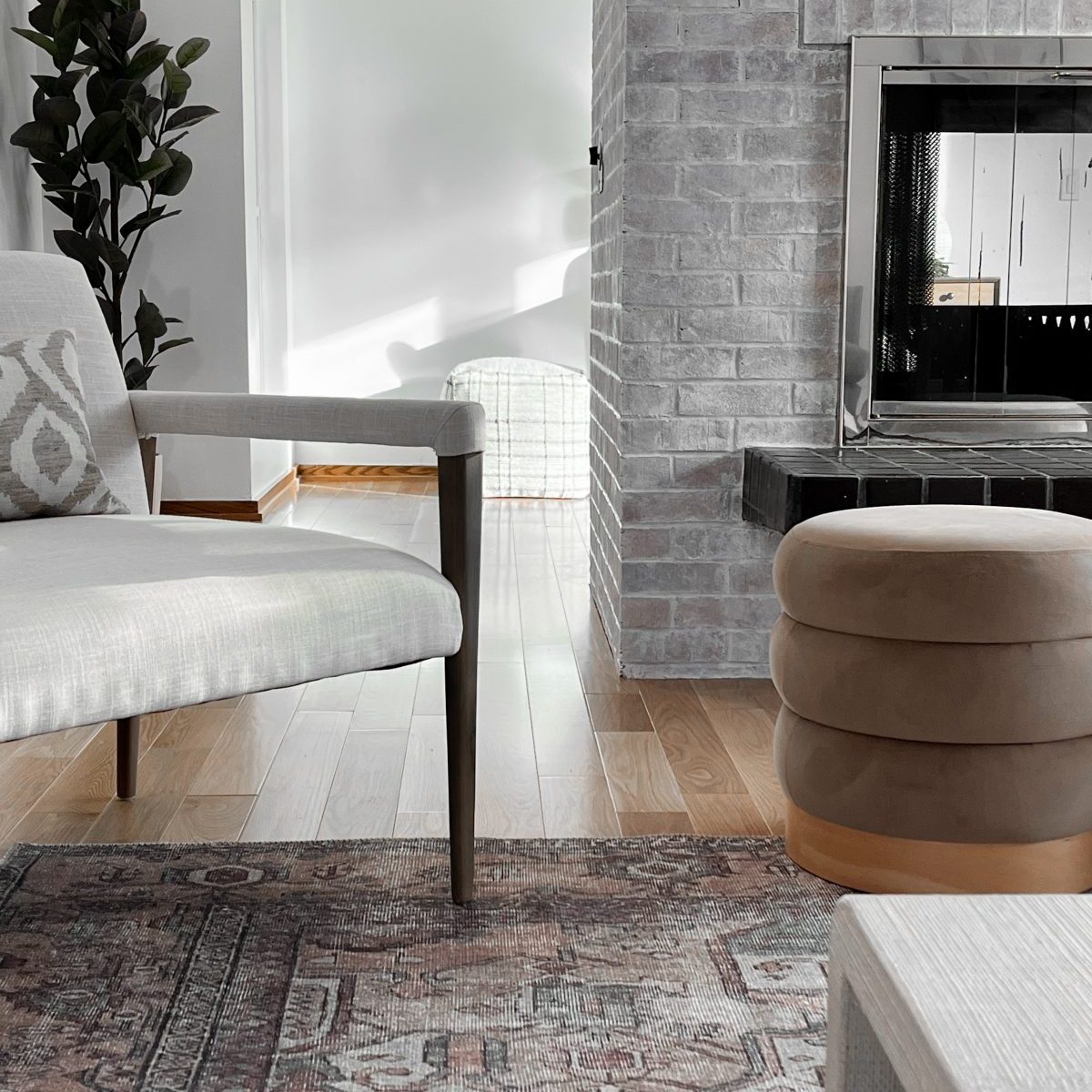 Modern armchair and ottoman in front of a living room fire place in Worthington, Ohio home