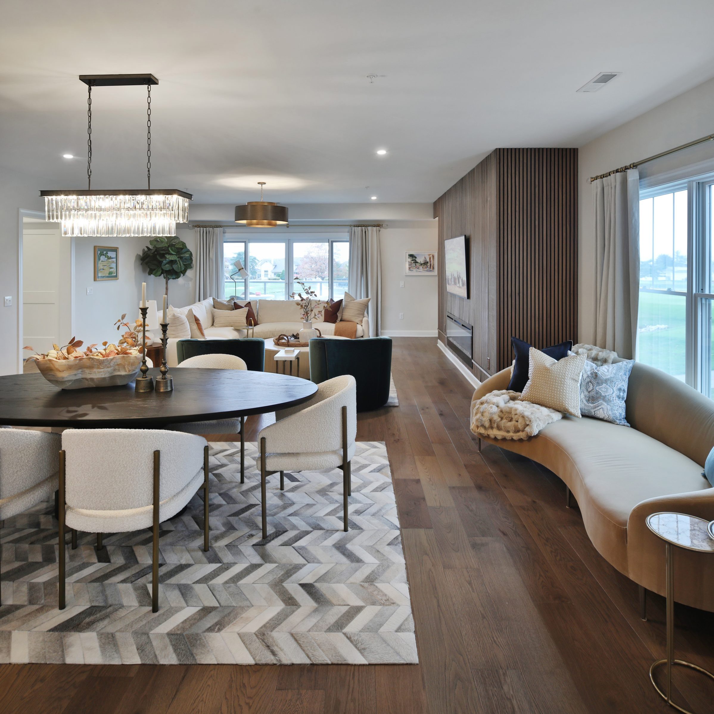 Overlooking a luxury dining space into a living room in a central Ohio condo up against country club golf course.