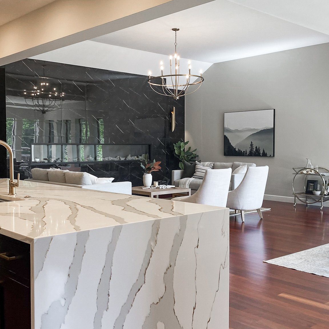 Overlooking a large custom installed waterfall style kitchen island into condo living room in Dublin, Ohio Home.