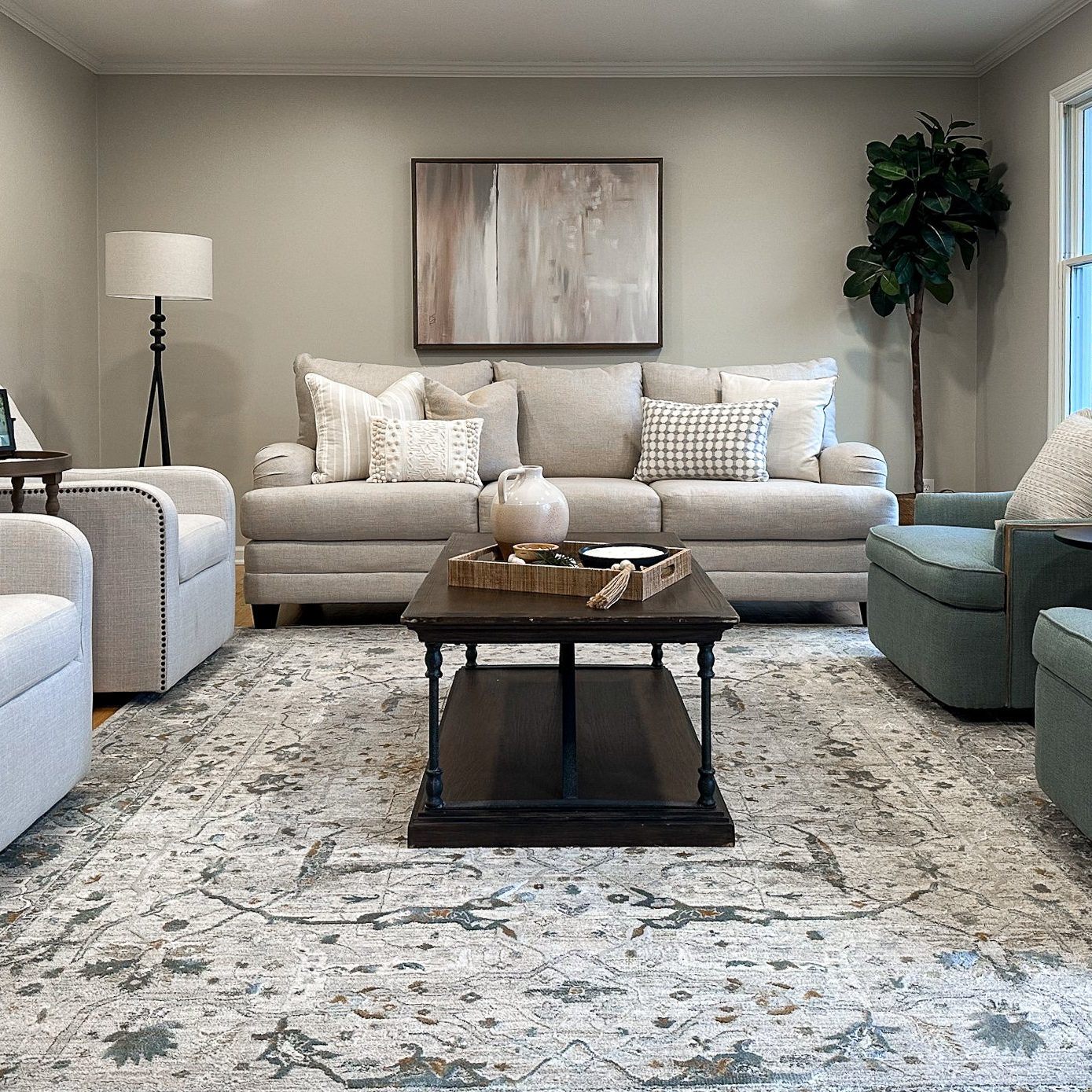 Family room staging in a Worthington Hills home styled with luxury occasional chairs, modern sofa and large area rug.