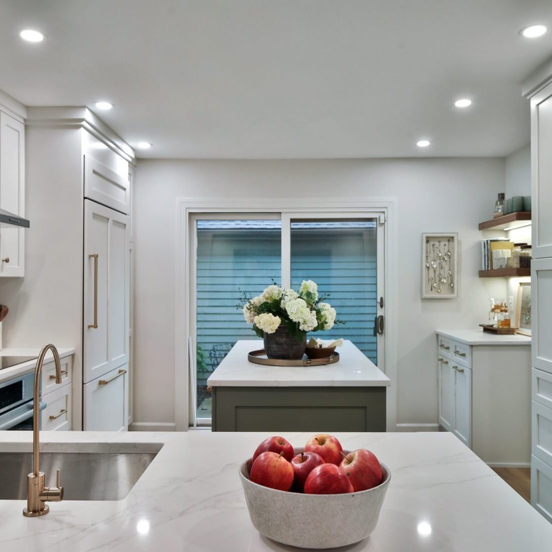Wide angle shot of a complete kitchen remodel in a central Ohio home, featuring custom cabinetry, white stone countertops and luxury appliances.